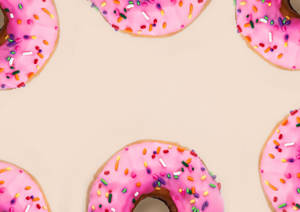 Pink Doughnuts Background Wallpaper