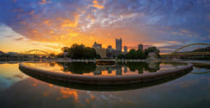 Pittsburgh Skyline At Dusk Cloud Cover Wallpaper