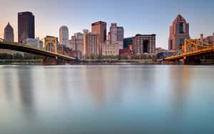 Pittsburgh Skyline Showing Two Bridge Crossings Wallpaper