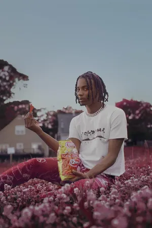 Playboi Carti In Flower Fields Aesthetic Rapper Wallpaper