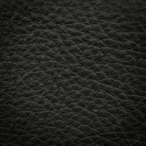 Polished Black Leather Exudes Luxury And Sophistication. Wallpaper