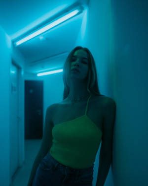 Posing Under Neon Blue Iphone Wallpaper