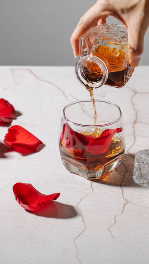 Pouring Glass Of Alcohol On Marble Wallpaper