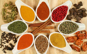 Powdered And Whole Spices On Wooden Surface Wallpaper