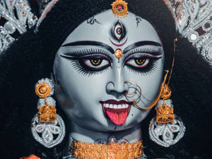 Powerful Divine Representation - Goddess Kali Adorned With Golden Accessories. Wallpaper