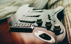 Powerful Image Of An Electric Stratocaster Guitar Being Played. Wallpaper