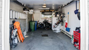 Practical And Efficient Garage Space Showing Car And Tools Storage Wallpaper