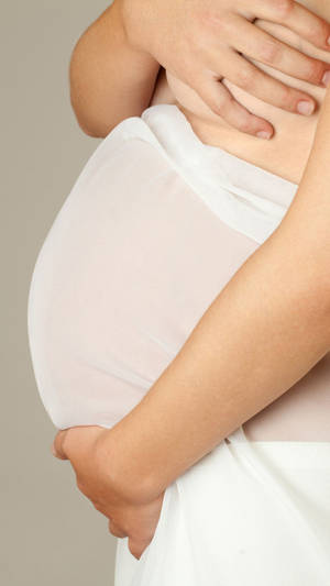 Pregnancy Covering Her Breasts Wallpaper