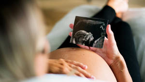 Pregnancy Holding Sonogram Wallpaper