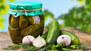 Preserved Pickles In A Round Glass Jar Wallpaper