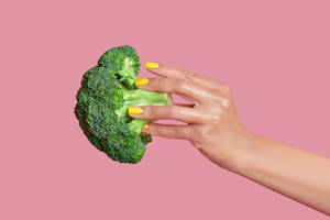 Pretty Hand Holds Green Broccoli Wallpaper