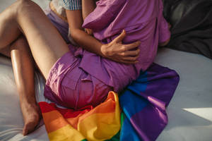 Pride Flag Couple Embracing Wallpaper