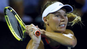 Pro Tennis Player Caroline Wozniacki In Action Wallpaper