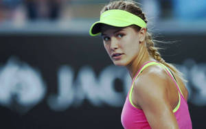 Pro Tennis Player Eugenie Bouchard Donning A Yellow Visor Wallpaper