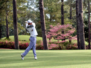 Professional Golfer Rory Mcilroy Hits A Full Swing At A Tournament Wallpaper