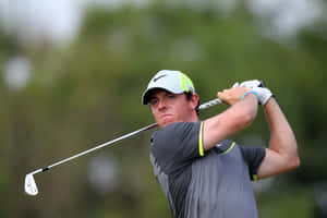 Professional Golfer Rory Mcilroy Taking A Swing Wallpaper