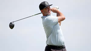 Professional Golfer, Scott Piercy, Posing Against A Grey Backdrop. Wallpaper