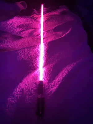 Purple Lightsaber On A Blanket Wallpaper