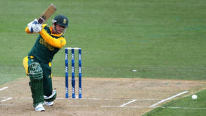 Quinton De Kock Kneeling On The Cricket Field Wallpaper