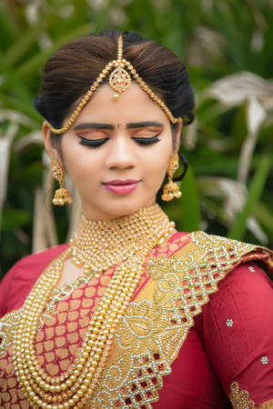 Radiant Elegance: An Indian Bride At Her Traditional Wedding Wallpaper