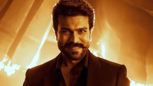 Ram Charan In High Definition Looking Dashing Against A Fiery Background Wallpaper