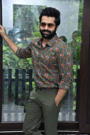 Ram Pothineni Posing Near Window Wallpaper