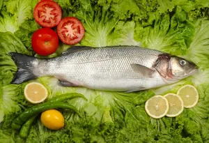 Raw Gray Mullet On Top Of Lettuce Wallpaper