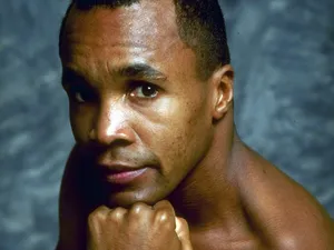 Ray Leonard Posing In Front Of Blue Backdrop Wallpaper