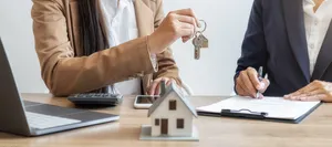 Real Estate Agent Handing Over House Keys Wallpaper