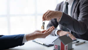 Real Estate Agent Handing Over House Keys Wallpaper