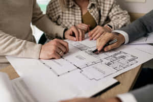 Real Estate Planning Concept - Agent With House Blueprint Wallpaper