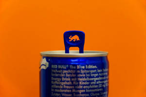 Red Bull Can On Orange Wall Wallpaper