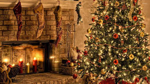 Red Gold Christmas Tree By The Fireplace Wallpaper