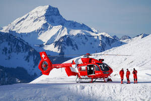 Red Helicopter On Snowy Mountain Wallpaper