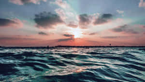 Relax On The Sand And Take In The Views Of A Stunning Beach Scene. Wallpaper