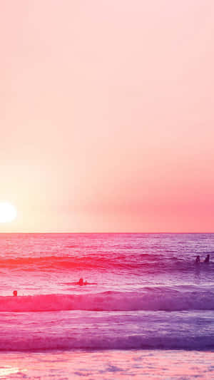 Relaxing At A Pink-hued Beach Wallpaper