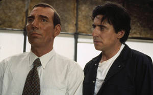 Renowned Actors Pete Postlethwaite And Gabriel Byrne In A Scene Wallpaper