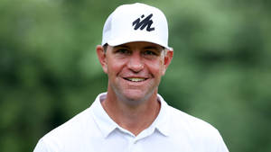 Renowned Golfer Lucas Glover In Striking White Attire Wallpaper