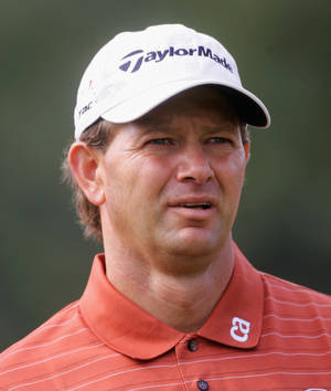 Retief Goosen Wearing A Taylormade White Hat During A Golf Tournament Wallpaper