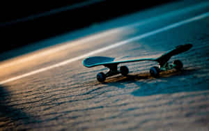 Retro Skateboard On Pavement Wallpaper