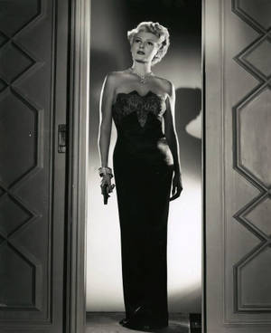 Rita Hayworth Holding A Gun Wallpaper