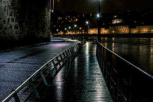 Riverside Walkway At Night Wallpaper