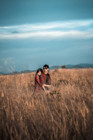 Romantic Couple Back Hug On Tall Grass Wallpaper