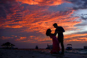 Romantic Couple Beach Dance At Dusk Wallpaper