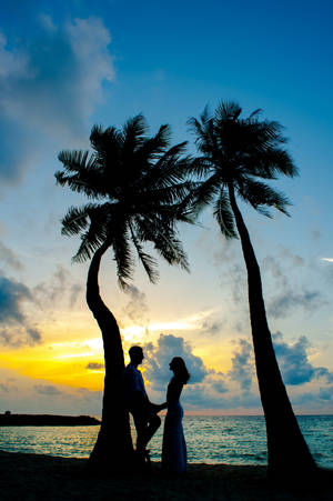 Romantic Couple By The Beach Palms Wallpaper