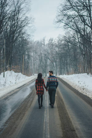 Romantic Couple Holding Hands On Road Wallpaper