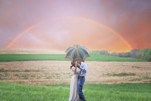 Romantic Couple Kiss Behind Umbrella Under Rainbow Wallpaper
