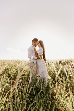 Romantic Couple On Grass Field Wallpaper