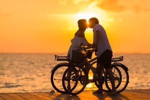Romantic Love Bicycles Under Sunset Wallpaper