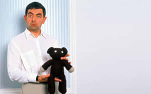 Rowan Atkinson Holding Teddy Wallpaper